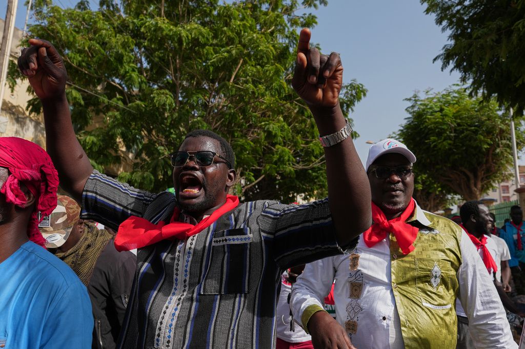 A worker gestures during a march to demand that the government honor its commitments and address their concerns in Dakar, Senegal, Wednesday, April 8, 2026. (AP Photo/Misper Apawu)