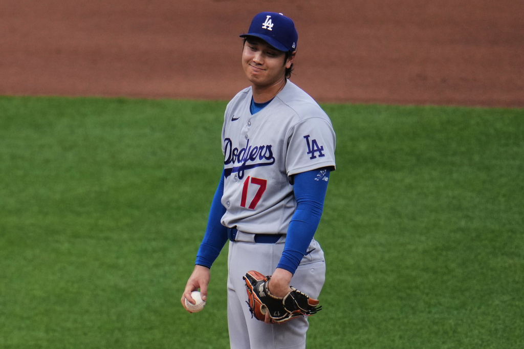 Los Angeles Dodgers two-way player Shohei Ohtani reacts on the mound after giving up a solo home run to Pittsburgh Pirates' Tyler Callihan during the fourth inning of a baseball game in Pittsburgh, Wednesday, June 10, 2026. (AP Photo/Gene J. Puskar)