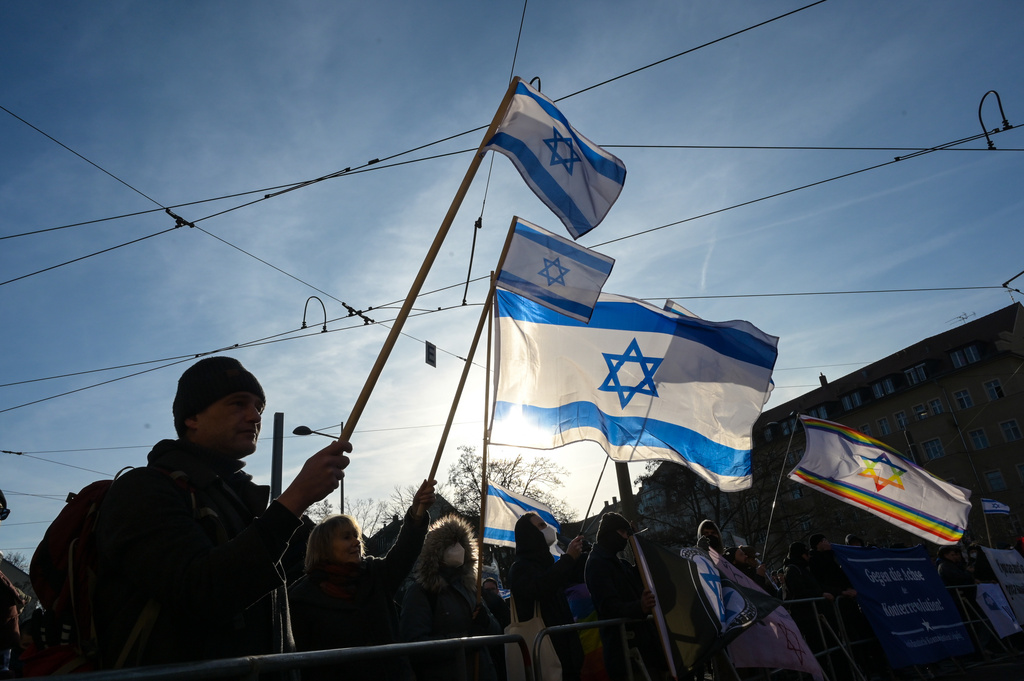 Participants gather hold up Israeli flags during a demonstration in Leipzig, Germany, Saturday, Jan. 17, 2026. (Heiko Rebsch/dpa via AP)