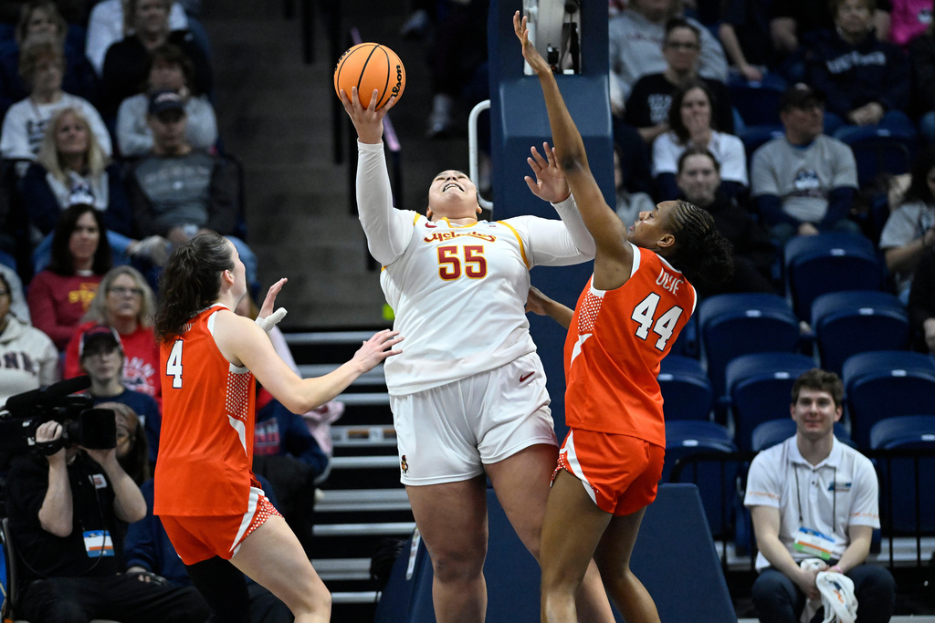 Iowa State center Audi Crooks (55) shoots between Syracuse guard Sophie Burrows (4) and center Uche Izoje (44) during the first half in the first round of the NCAA college basketball tournament, Saturday, March 21, 2026, in Storrs, Conn. (AP Photo/Jessica Hill)
