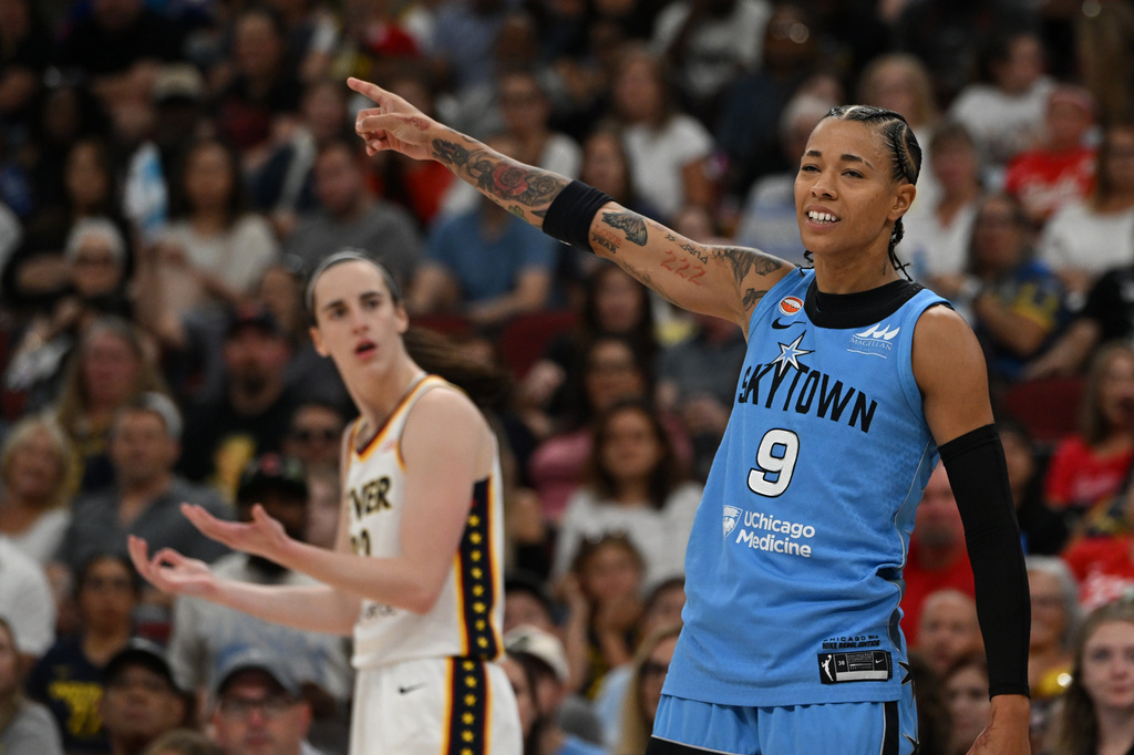 Chicago Sky's Natasha Cloud (9) signals that it's the Sky's possession after Indiana Fever's Caitlin Clark, left, was called for a foul during the second half of an WNBA basketball game against the Chicago Sky in Chicago, Saturday, Aug. 8, 2026. (AP Photo/Paul Beaty)