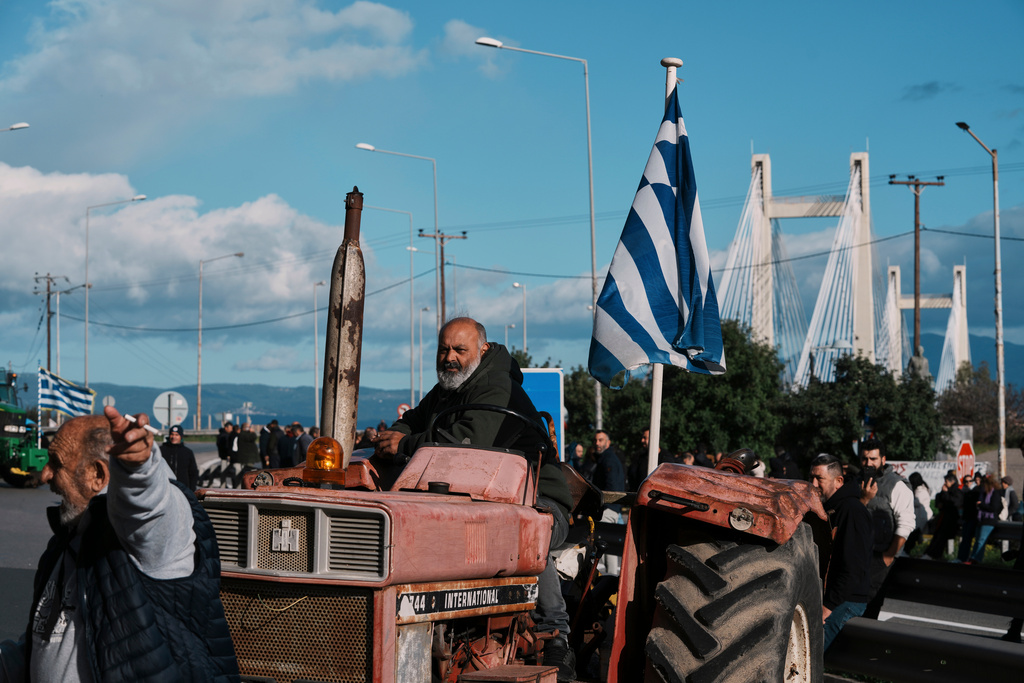 Farmers block the Chalkida Bridge with tractors during a protest over delays in European Union–backed agricultural subsidy payments, on Evia island, Greece, Thursday, Jan. 8, 2026. (AP Photo/Thanassis Stavrakis)