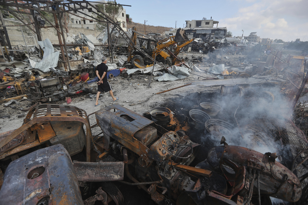 A Lebanese man inspects the site where Israeli airstrikes on Wednesday night hit bulldozers in Ansariyeh village, south Lebanon, Thursday, Sept. 4, 2025. (AP Photo/Mohammed Zaatari)