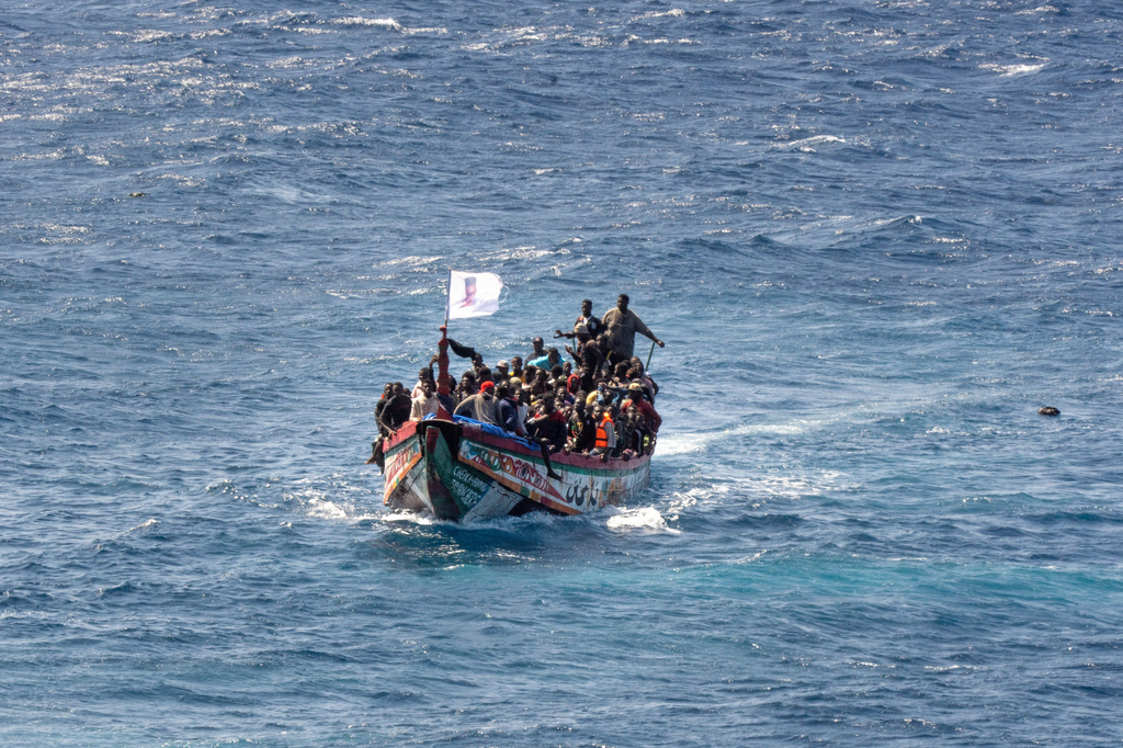 FILE - Migrants crowd a wooden boat as they sail to the port in La Restinga on the Canary island of El Hierro, Spain, Sunday, Aug. 18, 2024. (AP Photo/Maria Ximena, File)