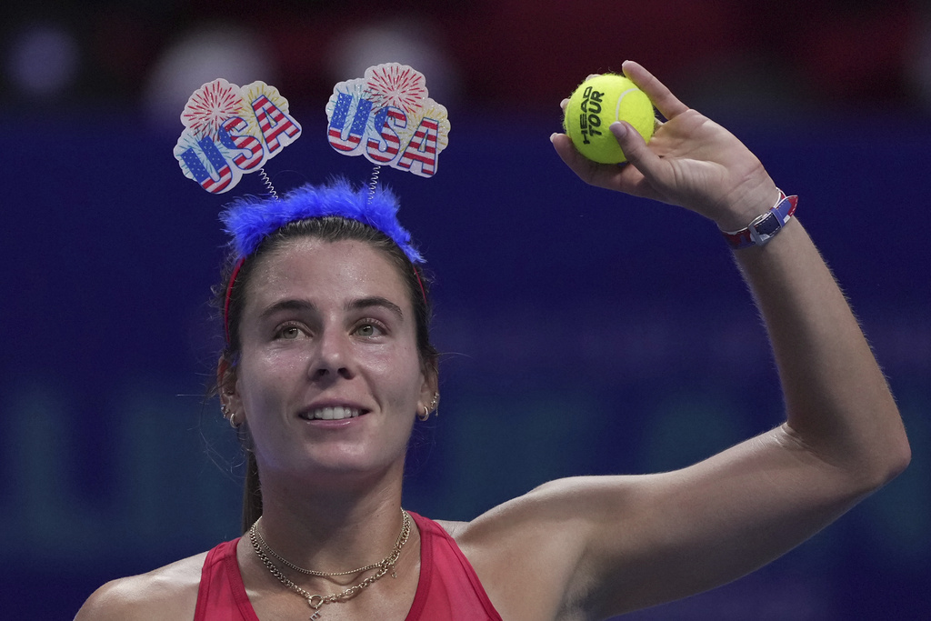Emma Navarro, of the United States prepares to hit the ball to spectators after winning in the Billie Jean King Cup semifinals tennis match against Sonay Kartal, of Britain, at the Shenzhen Bay Sports Center Arena, in Shenzhen, China's Guangdong province, Saturday, Sept. 20, 2025. (AP Photo/Andy Wong)