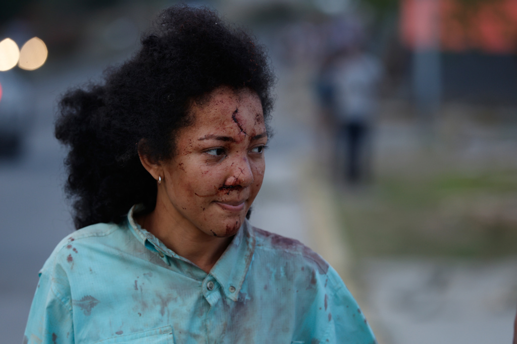An injured woman walks in La Guaira, Venezuela, a day after an earthquake struck the area, Thursday, June 25, 2026. (AP Photo/Pedro Mattey)