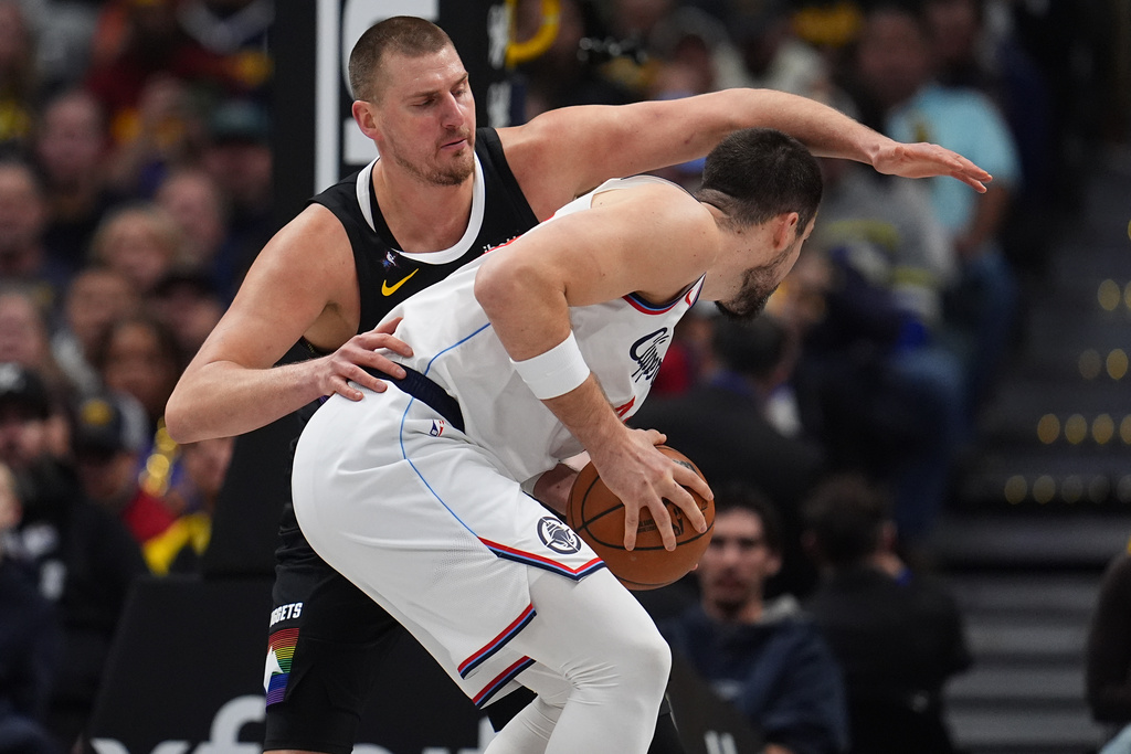 Los Angeles Clippers center Ivica Zubac, front, is covered by Denver Nuggets center Nikola Jokić, back, in the first half of an NBA basketball game Friday, Jan. 30, 2026, in Denver. (AP Photo/David Zalubowski)