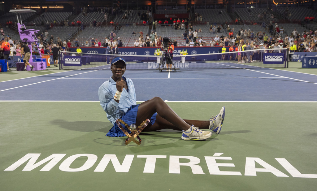 Victoria Mboko, of Canada, poses with the trophy after her win over Naomi Osaka, of Japan, in final action at the National Bank Open women's tennis tournament in Montreal, Thursday, Aug. 7, 2025. (Christinne Muschi/The Canadian Press via AP)
