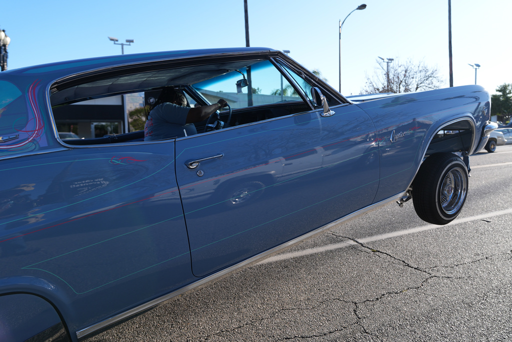 Tina L. Blankenship-Early rides her 1966 Chevrolet Caprice "Game Killa" at the 6th Annual Lady Lowrider Cruise Night in celebration of International Women's Day in Pasadena, Calif., on Sunday, March 8, 2026. (AP Photo/Damian Dovarganes)