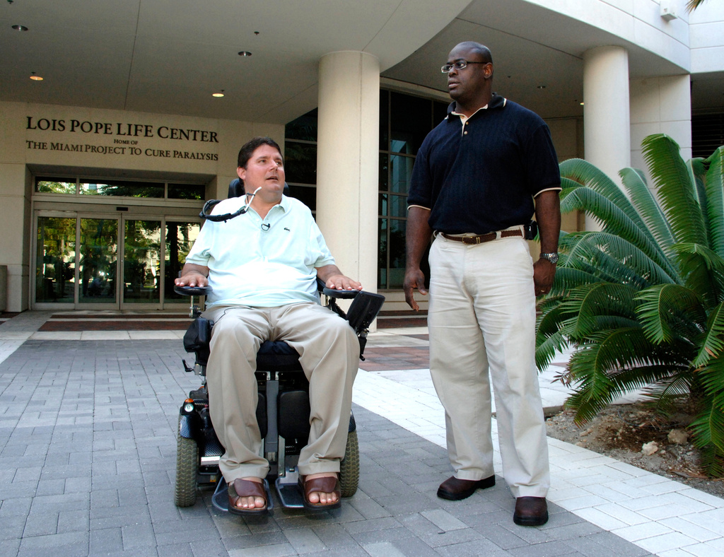 In this photo released by the University of Miami, The Buoniconti Fund to Cure Paralysis President Marc Buoniconti and former East Tennessee State running back Herman Jacobs at The Miami Project to Cure Paralysis on the University of Miami Miller School of Medicine campus in 2007. (Rob Camarena/University of Miami via AP)