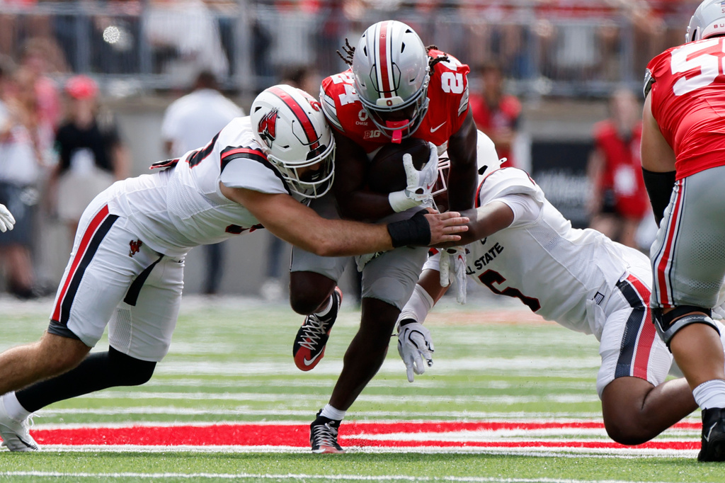 Ball State defenders Donovan Lanier, left, and Cincear Lewis tackle Ohio State running back Ja'Kobi Jackson during the first half of an NCAA college football game, Saturday, Sept. 5, 2026, in Columbus, Ohio. (AP Photo/Jay LaPrete)