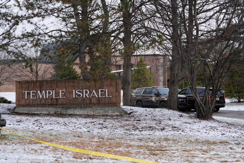 Police vehicles sit outside the Temple Israel synagogue Friday, March 13, 2026, in West Bloomfield Township, Mich. (AP Photo/Paul Sancya)