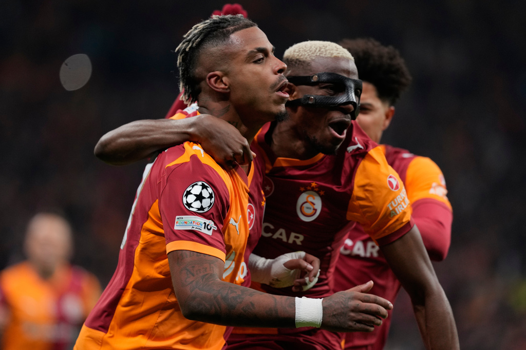 Galatasaray's Mario Lemina, left, celebrates after scoring the opening goal during a Champions League round of 16 first leg soccer match between Galatasaray and Liverpool, in Istanbul, Turkey, Tuesday, March 10, 2026. (AP Photo/Khalil Hamra)