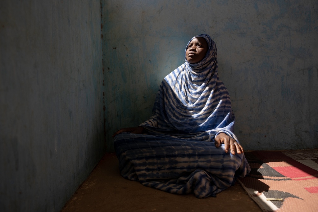 Moyme, who fled Mali in fear of the Malian Army and its Russian allies, poses for a portrait Tuesday, Nov. 4, 2025, in a camp in Mbera, Mauritania, where she has found refuge. (AP Photo/Caitlin Kelly)