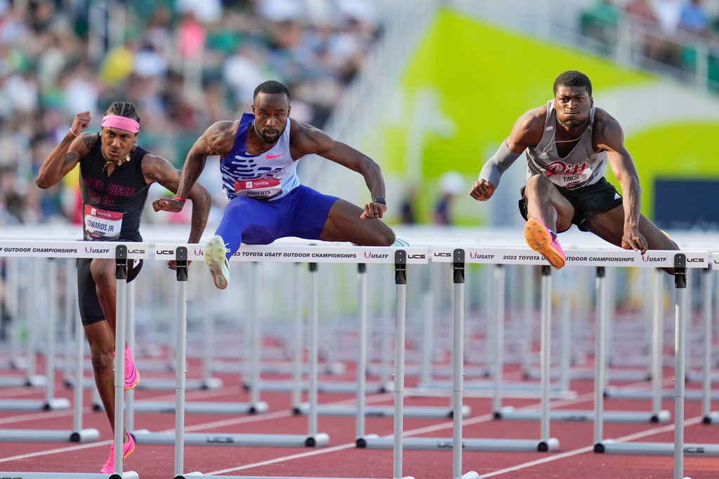 FILE - Daniel Roberts and Cordell Tinch compete in the men's 110 meter hurdles semifinal during the U.S. track and field championships in Eugene, Ore., Sunday, July 9, 2023. Left is Eric Edwards. (AP Photo/Ashley Landis, File)