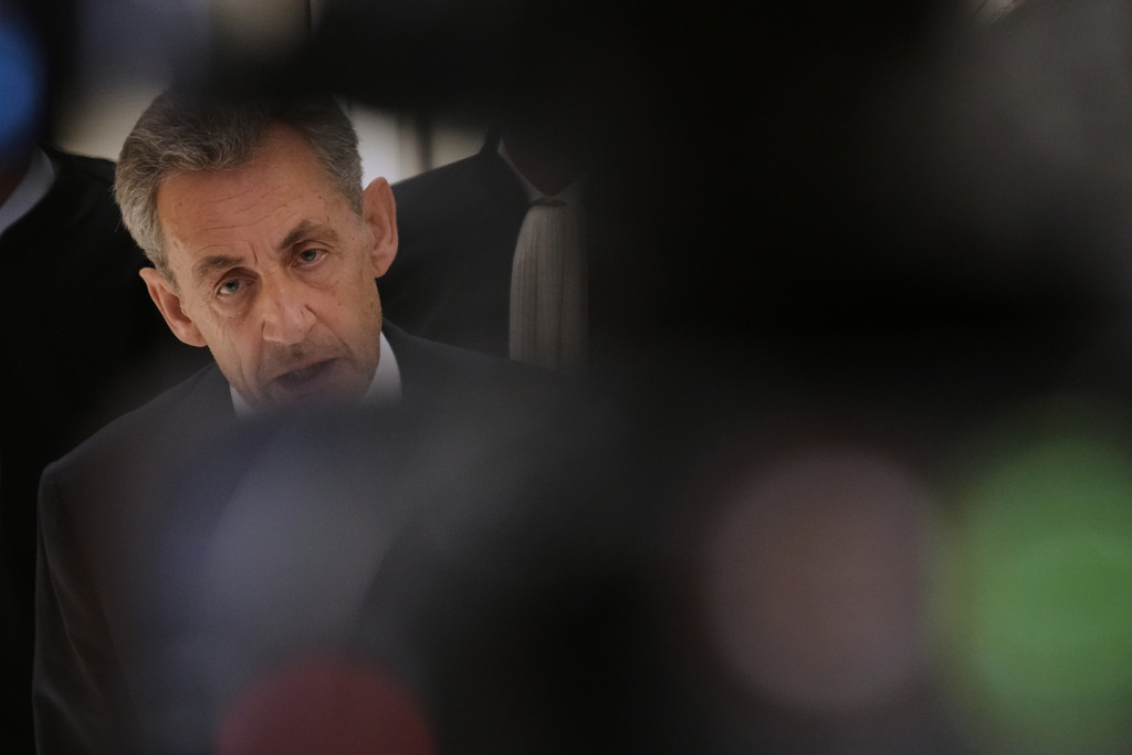FILE-Former French President Nicolas Sarkozy speaks with the media after a Paris court sentenced him to 5 years after finding him guilty of criminal conspiracy in an alleged scheme to finance his 2007 campaign with funds from Libya, Thursday, Sept. 25, 2025 in Paris. (AP Photo/Christophe Ena, File)