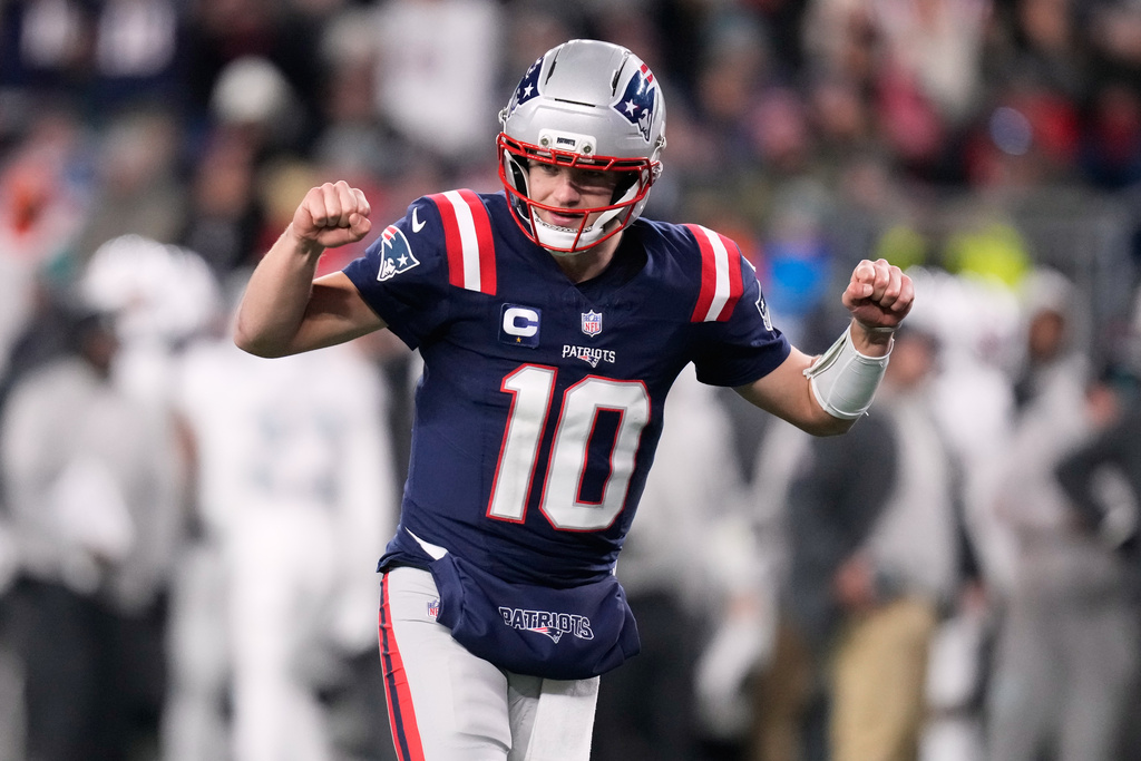 New England Patriots quarterback Drake Maye celebrates after a touchdown scored by running back TreVeyon Henderson during the second half of an NFL football game against the Miami Dolphins in Foxborough, Mass., Sunday, Jan. 4, 2026. (AP Photo/Charles Krupa)