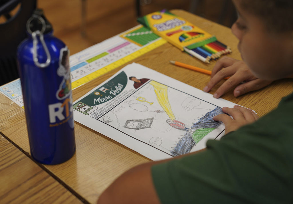Mateo Jones, a fifth-grade student at St. John Berchmans' school draws a picture of Blessed Carlo Acutis, who will be canonized a saint by Pope Leo XIV, during a class activity on Wednesday, Sept. 3, 2025, in Chicago. (AP Photo/Jessie Wardarski)