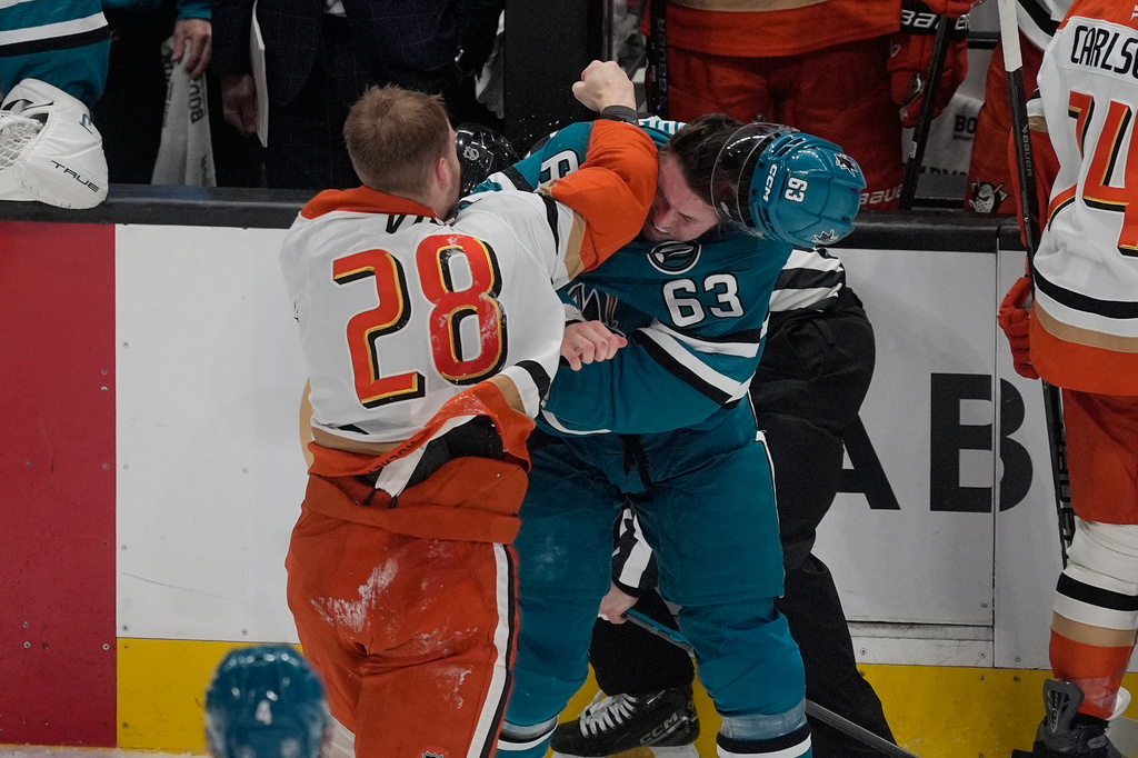Anaheim Ducks left wing Jeffrey Viel (28) fights with San Jose Sharks center Zack Ostapchuk (63) during the third period of an NHL hockey game in San Jose, Calif., Wednesday, April 1, 2026. (AP Photo/Jeff Chiu)