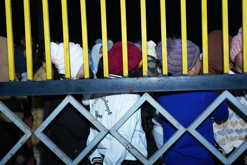 Voters wait for a polling station to open in Naypyitaw, Myanmar, Sunday, Dec. 28, 2025. (AP Photo/Aung Shine Oo)