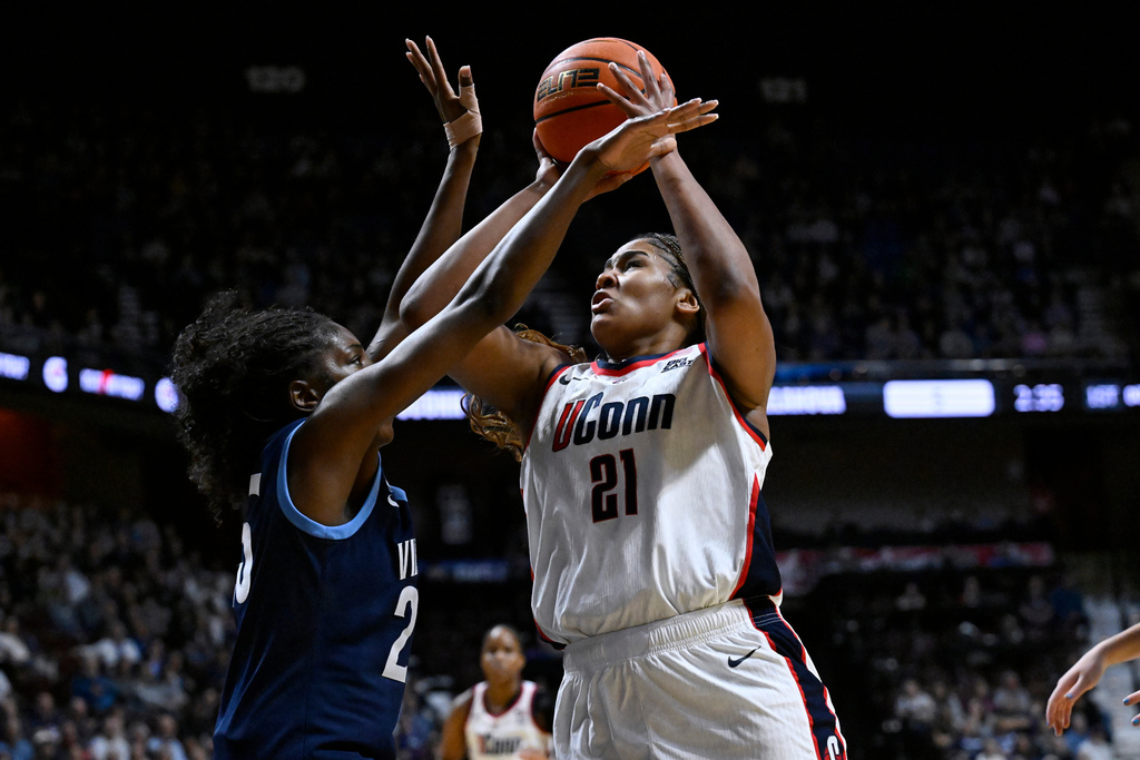 UConn forward Sarah Strong, right, shoots as Villanova forward Denae Carter, left, defends during first half of an NCAA college basketball game in the finals of the Big East tournament, Monday, March 9, 2026, in Uncasville, Conn. (AP Photo/Jessica Hill)