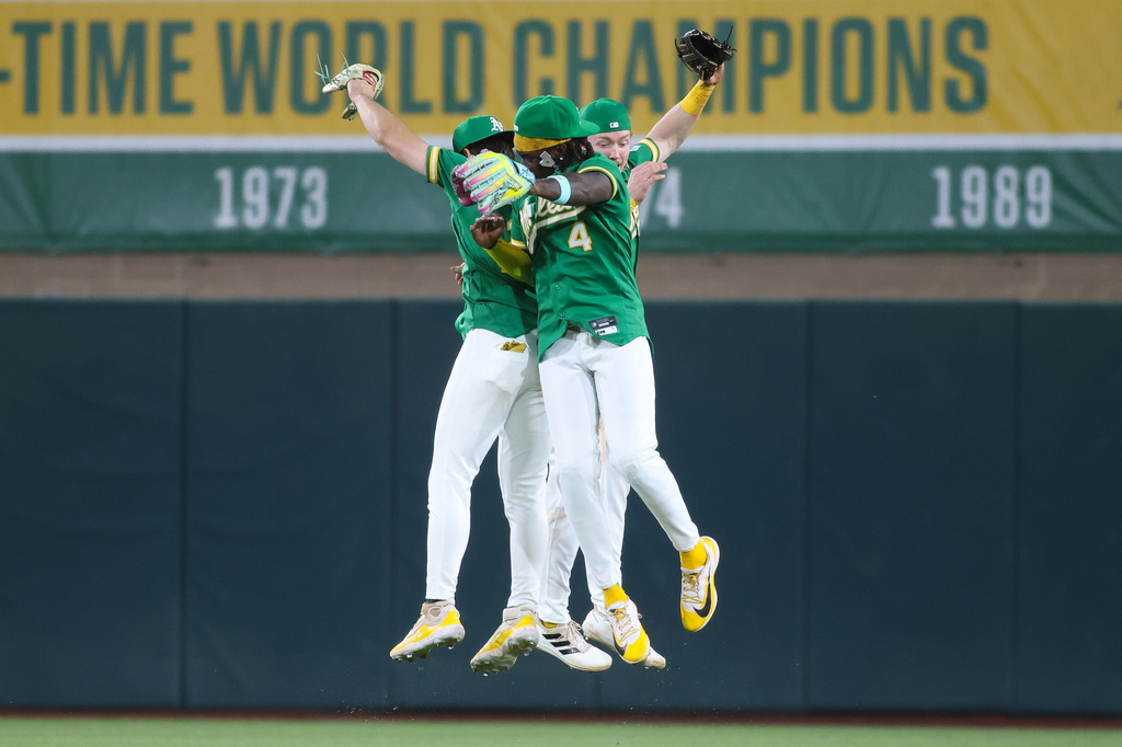 Athletics' Tyler Soderstrom, left, Lawrence Butler (4), and Henry Bolte celebrate the Athletics win over the Pittsburgh Pirates in a baseball game Monday, June 15, 2026, in West Sacramento, Calif. (AP Photo/Scott Marshall)