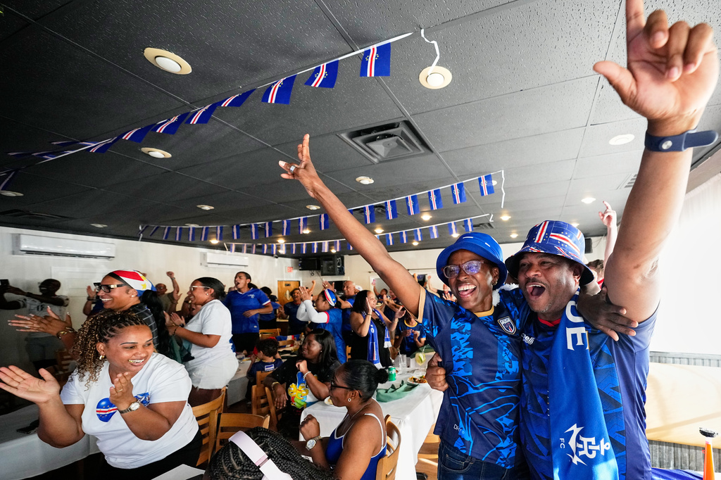 Cape Verde supporters celebrate the opening goal for their team as they watch the World Cup Group H soccer match between Uruguay and Cape Verde at a restaurant at a Cape Verde community in Brockton, Mass. near Boston, Sunday, June 21, 2026. (AP Photo/Martin Meissner)