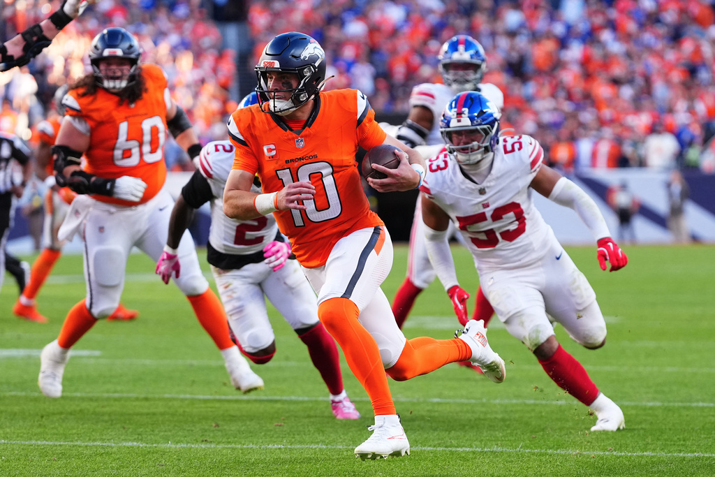 Denver Broncos quarterback Bo Nix (10) runs toward the end zone to score against the New York Giants during the second half of an NFL football game in Denver, Sunday, Oct. 19, 2025. (AP Photo/Jack Dempsey)