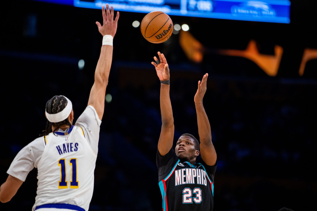 Memphis Grizzlies forward Cedric Coward (23) shoots against Los Angeles Lakers center Jaxson Hayes (11) during the first half of an NBA basketball game Sunday, Jan. 4, 2026, in Los Angeles. (AP Photo/Ethan Swope)