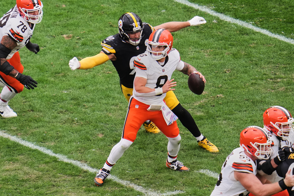 Cleveland Browns quarterback Dillon Gabriel (8) passes under pressure from Pittsburgh Steelers outside linebacker T.J. Watt (90) in the second half of an NFL football game in Pittsburgh, Sunday, Oct. 12, 2025. (AP Photo/Gene J. Puskar)