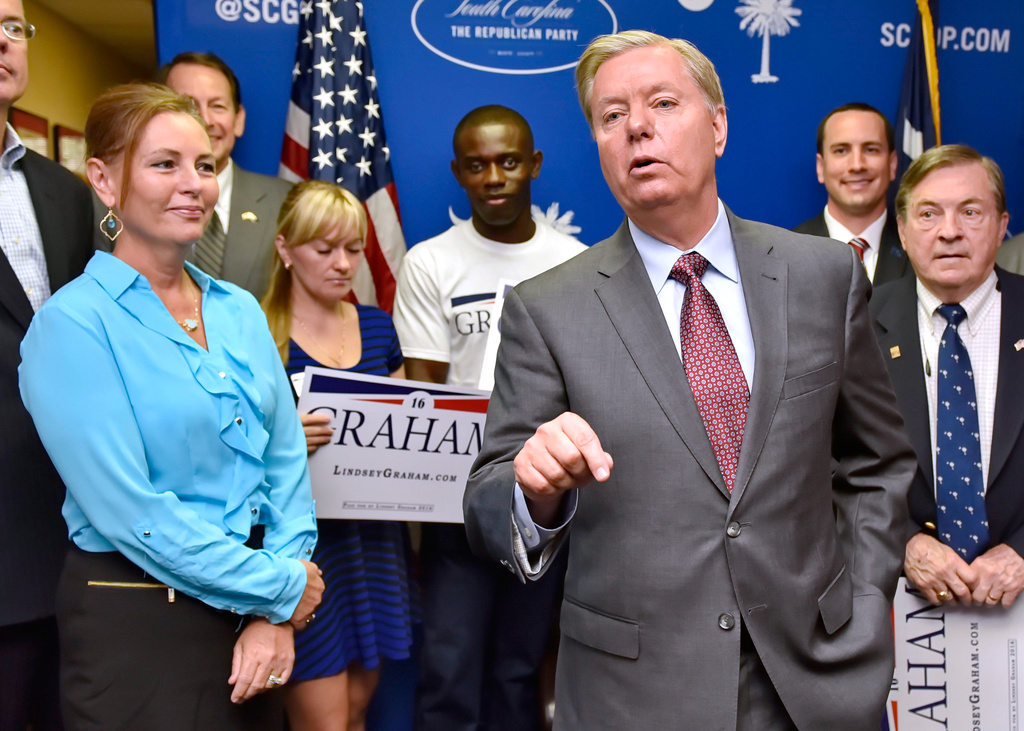 FILE - Republican presidential candidate, Sen. Lindsey Graham, R-S.C., accompanied by his sister Darline, left, speaks at the GOP headquarters in Columbia, S.C., Sept. 1, 2015, where he filed for the South Carolina Presidential Primary. (AP Photo/Richard Shiro, File)