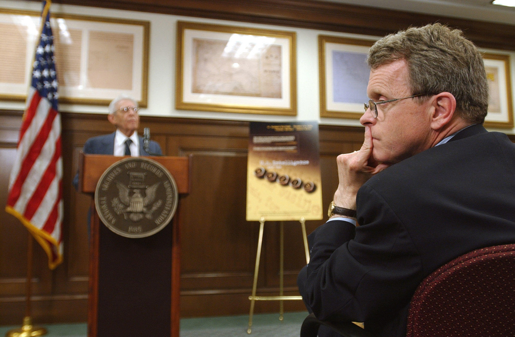 FILE - Sen. Mike DeWine, R-Ohio, right, looks on as former National Archives employee Robert Wolfe speaks at a Washington news conference, May 13, 2004. (AP Photo/Susan Walsh, File)