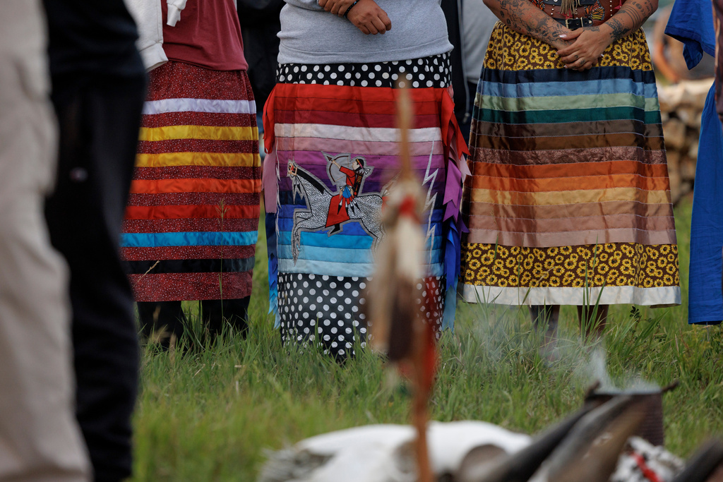 Ladies line up in ribbon skirts during festivities to commemorate the 150th anniversary of the Battle of the Little Bighorn, Wednesday, June 24, 2026, in Crow Agency, Mont. (AP Photo/Tailyr Irvine)