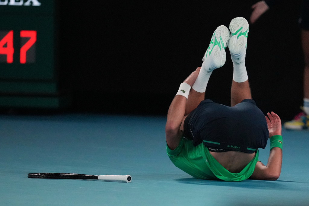 Novak Djokovic of Serbia falls during his third round match against Botic van de Zandschulp of the Netherlands at the Australian Open tennis championship in Melbourne, Australia, Saturday, Jan. 24, 2026. (AP Photo/Dita Alangkara)