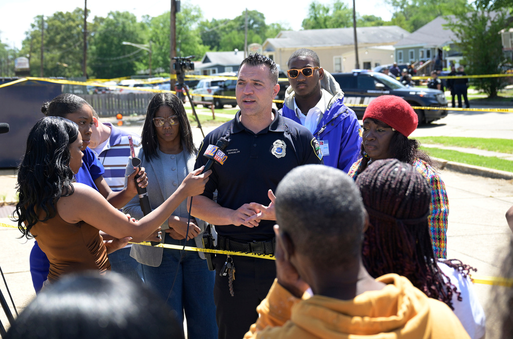 Shreveport Police spokesman Cpl. Chris Bordelon speaks to the news media and others gathered at the corner of Linwood Avenue and 79th Street near where a mass shooting took place in Shreveport, La., Sunday, April 19, 2026. (Jill Pickett/The Times-Picayune/The New Orleans Advocate via AP) CORRECTION: Police spokesman city title spelling corrected to Shreveport, instead of Shreverport
