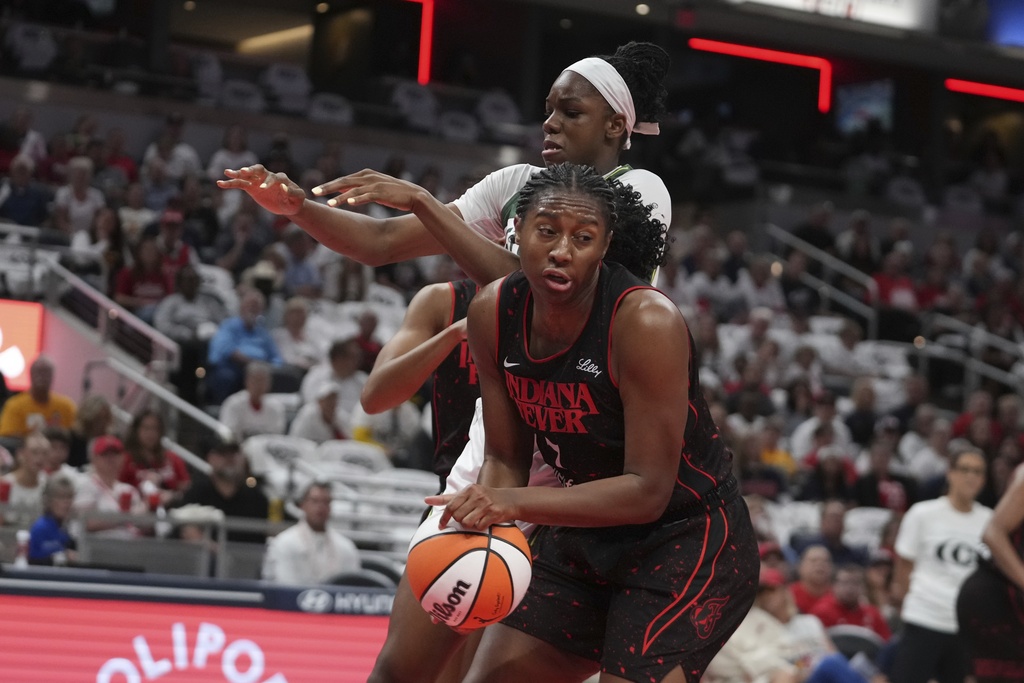 Indiana Fever forward Aliyah Boston grabs a rebound from Seattle Storm center Dominique Malonga during the first half of a WNBA basketball game, Tuesday, Aug. 26, 2025, in Indianapolis. (AP Photo/Darron Cummings)