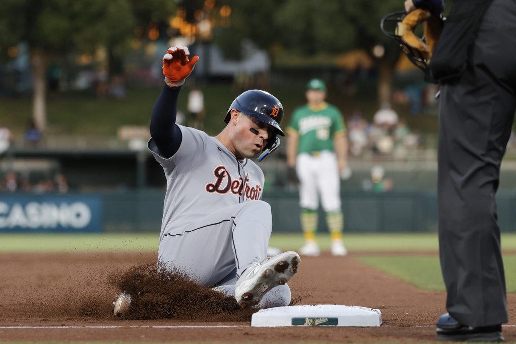 Detroit Tigers' Spencer Torkelson slides into third base after hitting a triple during the second inning of a baseball game against the Athletic,s Wednesday, Aug. 27, 2025, in West Sacramento, Calif. (AP Photo/Sergio Estrada)