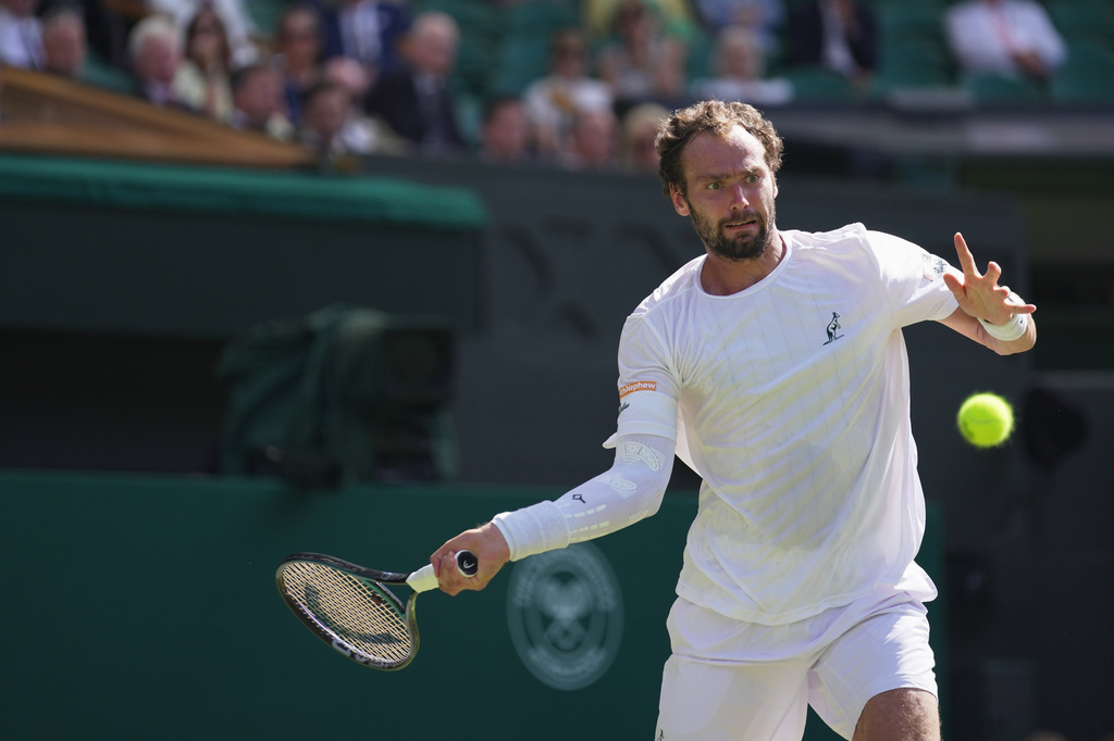 Roman Saffiullin of Russia returns the ball to Novak Djokovic of Serbia in their fourth round men's singles match at the Wimbledon Tennis Championships in London, Sunday, July 5, 2026. (AP Photo/Brian Inganga)