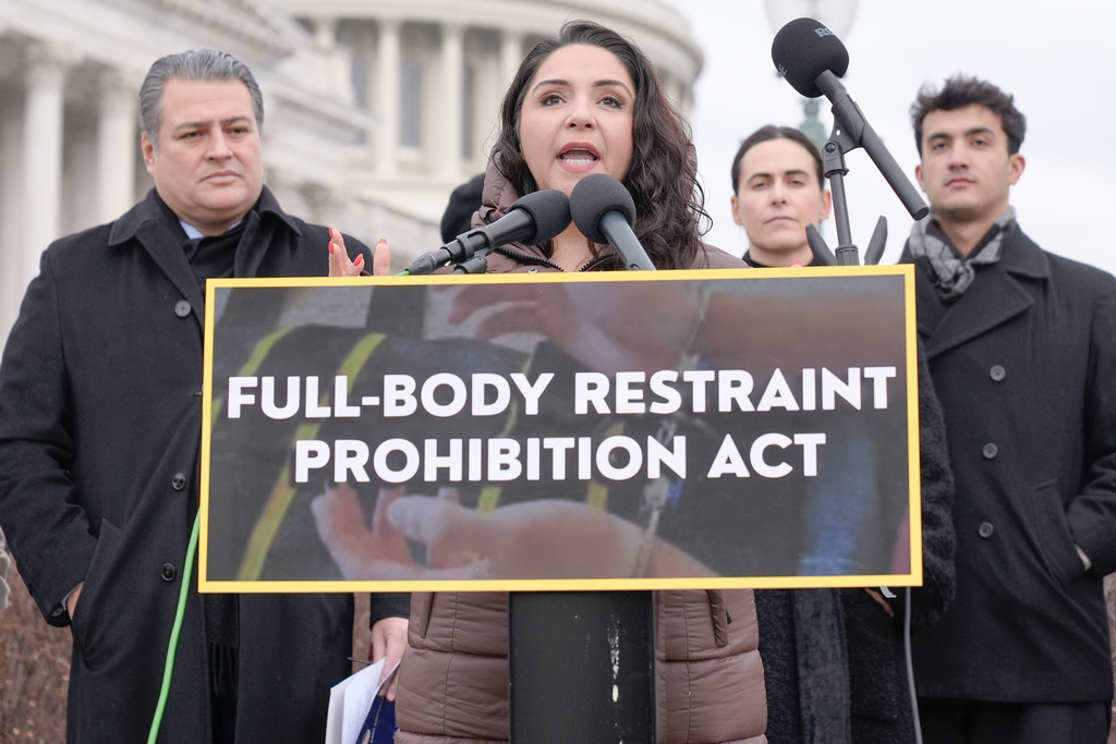 Rep. Delia Ramirez, D-Ill,center, speaks during a news conference to introduce The Full Body Restraint Prohibition Act on Capitol Hil, Wednesday, Feb. 25, 2026, in Washington. (AP Photo/Mariam Zuhaib)