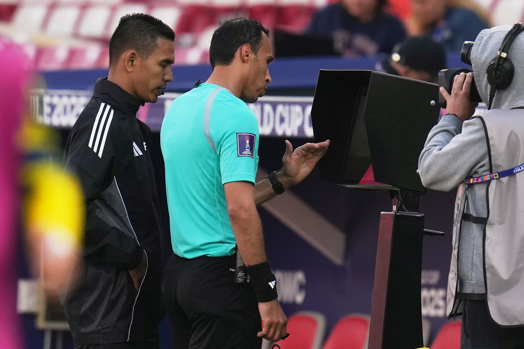 Referee Khalid Saleh Alturais checks the VAR screen during a FIFA U-20 World Cup Group B soccer match between Ukraine and Paraguay at National Stadium in Santiago, Chile, Friday, Oct. 3, 2025. (AP Photo/Esteban Felix)