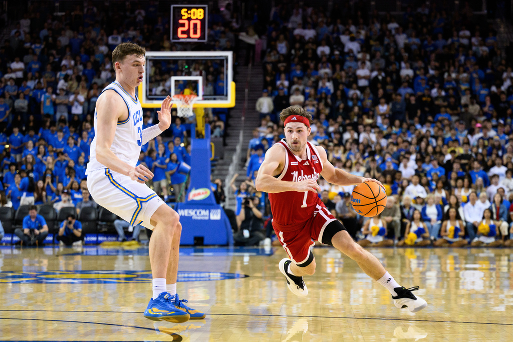 Nebraska guard Sam Hoiberg (1) drives the ball past UCLA forward Tyler Bilodeau during the first half of an NCAA college basketball game Tuesday, March 3, 2026, in Los Angeles. (AP Photo/William Liang)
