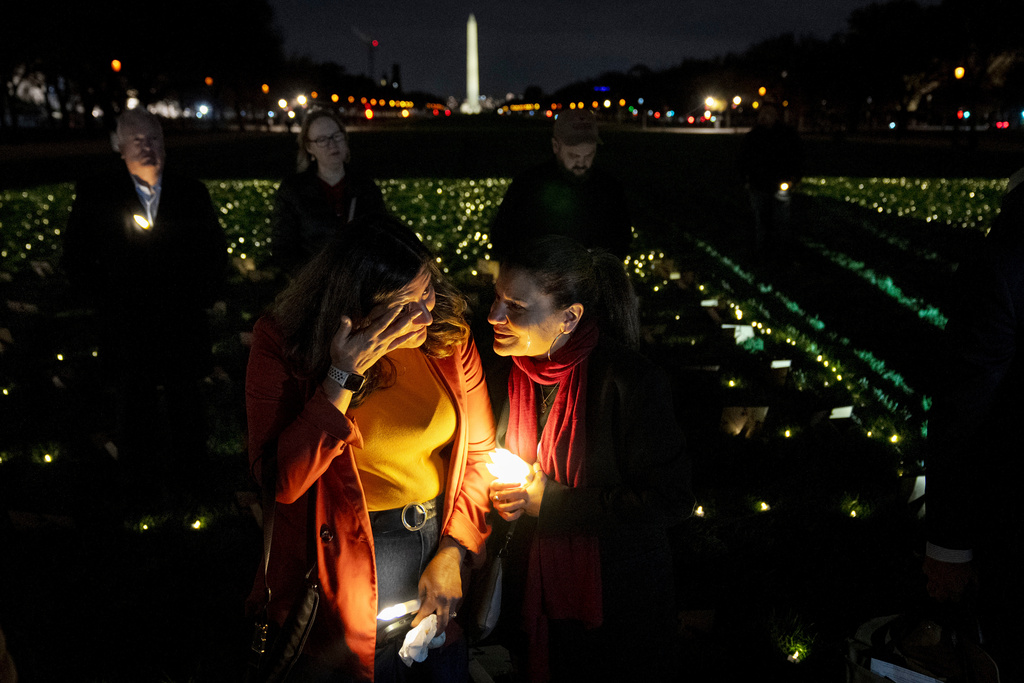 FILE - Madiha Maria, left, cries with Rana Abbas Taylor of Northville, Mich., who lost her only sister, brother-in-law and their three children to a drunk driver, during a candlelight vigil for people who had family members killed by drunk drivers, Tuesday, Nov. 19, 2024, on the National Mall, in Washington. (AP Photo/Jacquelyn Martin, File)