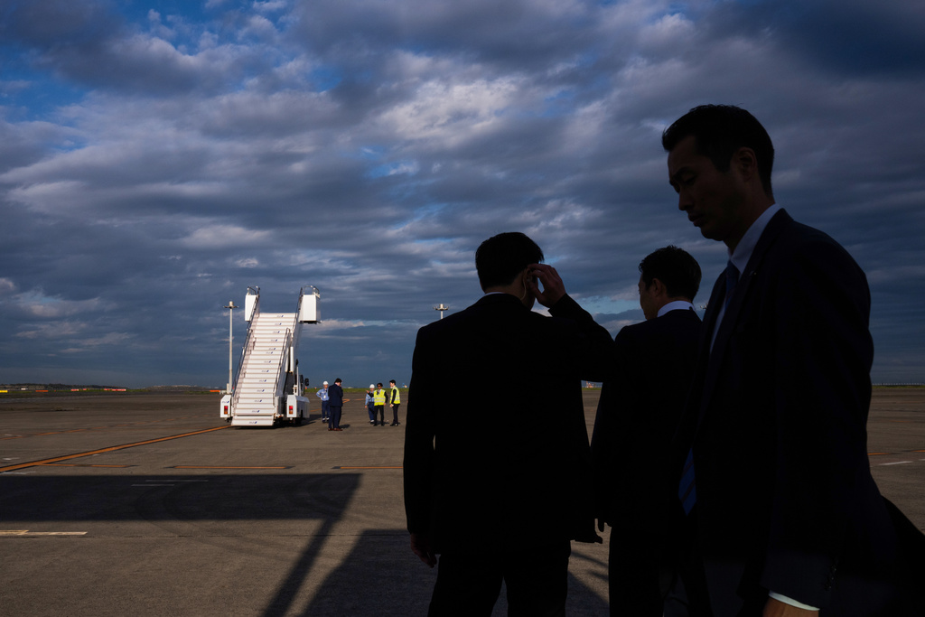 Security personnel take position just before the arrival of President Donald Trump in Air Force One at Haneda International Airport in Tokyo, Monday, Oct. 27, 2025. (AP Photo/Louise Delmotte)
