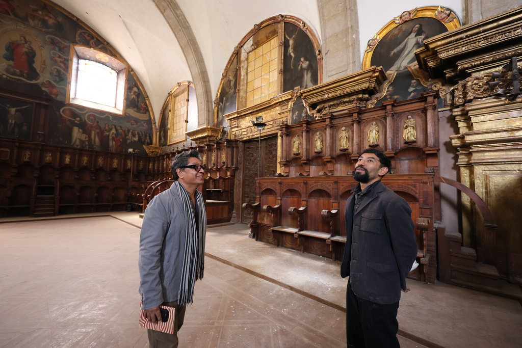 Architect Jesus Martínez, left, and art historian Alejandro Hernandez stand inside the restored choir area of Santo Domingo church in Mexico City, Tuesday, Jan. 27, 2026. (AP Photo/Ginnette Riquelme)