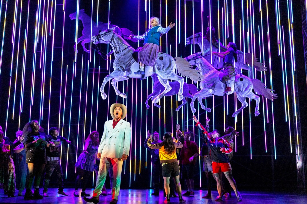 This image released by the Scottish Opera shows Justin Austin, foreground center, and Susan Bullock, top center, during a performance of "The Galloping Cure," at Theatre Royal Glasgow on July 28, 2026 in Glasgow, Scotland. (Antonia Bain/Scottish Opera via AP)