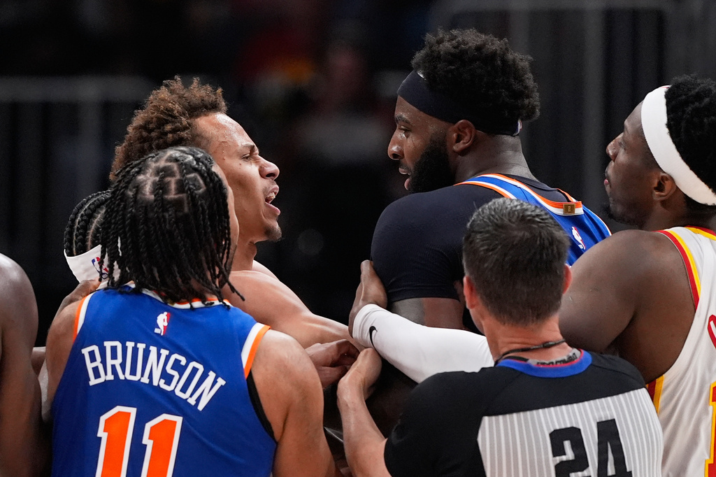 New York Knicks center Mitchell Robinson (23) and Atlanta Hawks guard Dyson Daniels (5) fight in the first half during Game 6 in a first-round NBA basketball playoffs series Thursday, April 30, 2026, in Atlanta. (AP Photo/Brynn Anderson)