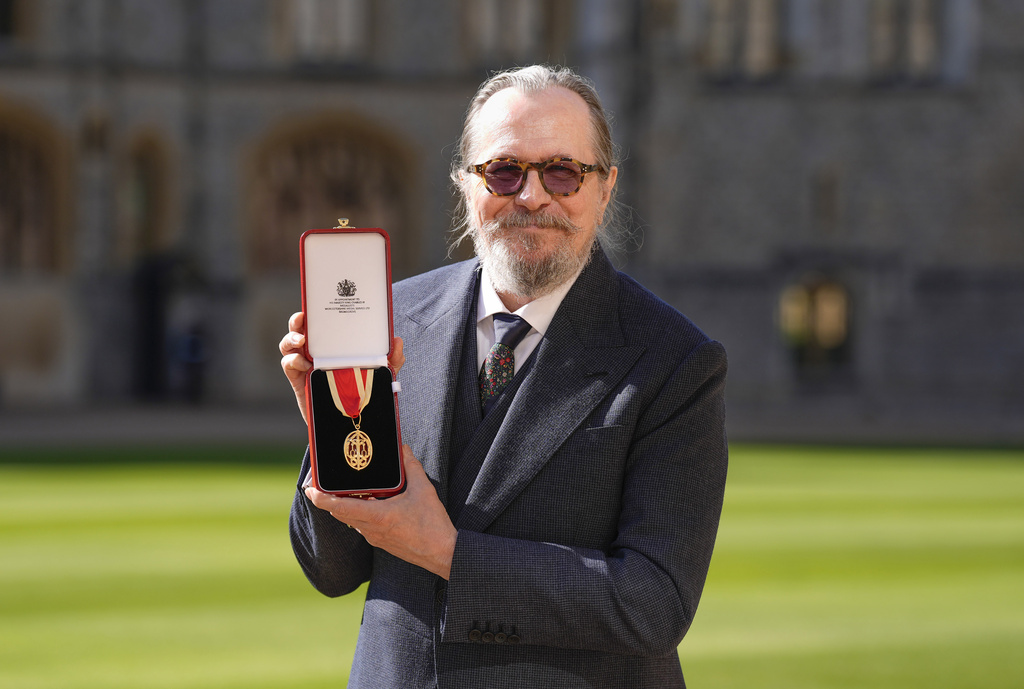 Actor Gary Oldman poses for a photo after being made a Knight Bachelor at an investiture ceremony at Windsor Castle, in Windsor, England, Tuesday, Sept. 30, 2025. (Andrew Matthews/Pool Photo via AP)