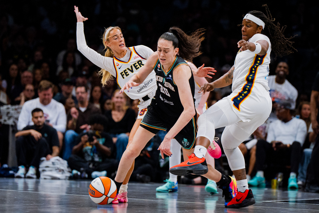 Indiana Fever guard Sophie Cunningham (8) fouls New York Liberty forward Breanna Stewart (30) during the second half of a WNBA basketball game, Saturday, Aug. 22, 2026, in New York. (AP Photo/Angelina Katsanis)