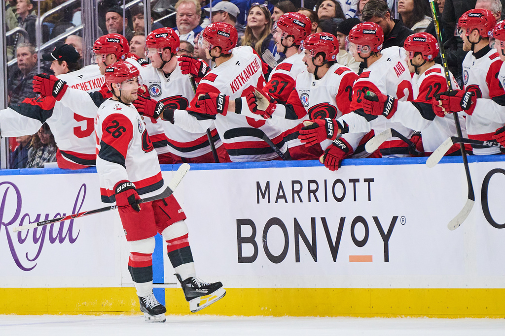 Carolina Hurricanes' Sean Walker (26) celebrates his goal against the Toronto Maple Leafs during second period NHL hockey action in Toronto, on Sunday, Nov. 9, 2025. (Sammy Kogan/The Canadian Press via AP)