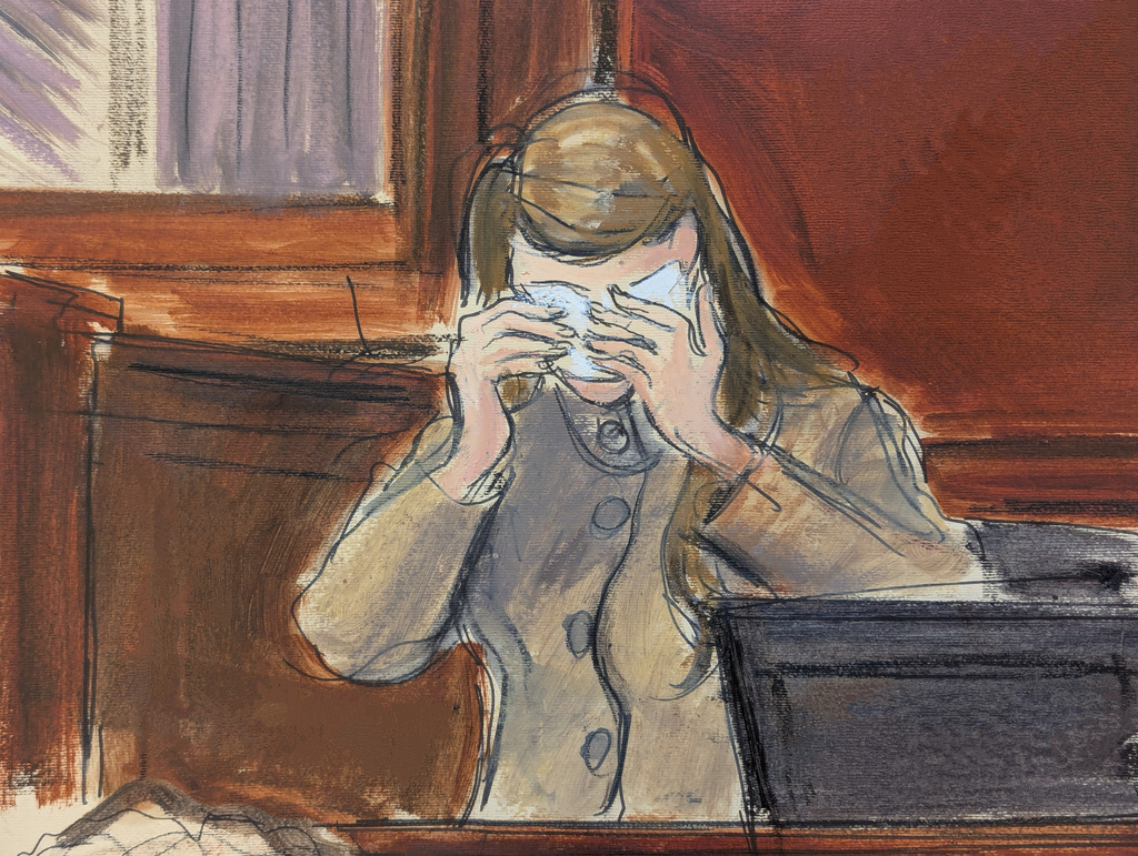 In this courtroom sketch, a witness, testifying under the pseudonym "Katie Moore," cries on the witness stand in Manhattan federal court on the first day of the sex trafficking trial of Alon Alexander, Oren Alexander and Tal Alexander, Tuesday, Jan. 27, 2026, in New York. (Elizabeth Williams via AP)